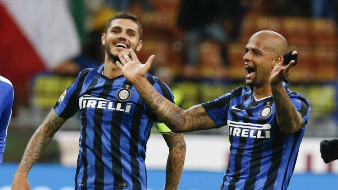 Inter Milan's Felipe Melo, right, celebrates with teammate Mauro Icardi at the end of a Serie A soccer match between Inter Milan and Hellas Verona, at the San Siro stadium in Milan, Italy, Wednesday, Sept. 23, 2015. Melo scored and Inter won 1-0. (AP Photo/Luca Bruno)