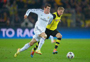 DORTMUND, GERMANY - APRIL 08:  Gareth Bale of Real Madrid takes on Oliver Kirch of Borussia Dortmund during the UEFA Champions League Quarter Final second leg match between Borussia Dortmund and Real Madrid at Signal Iduna Park on April 8, 2014 in Dortmund, Germany.  (Photo by Dennis Grombkowski/Bongarts/Getty Images)